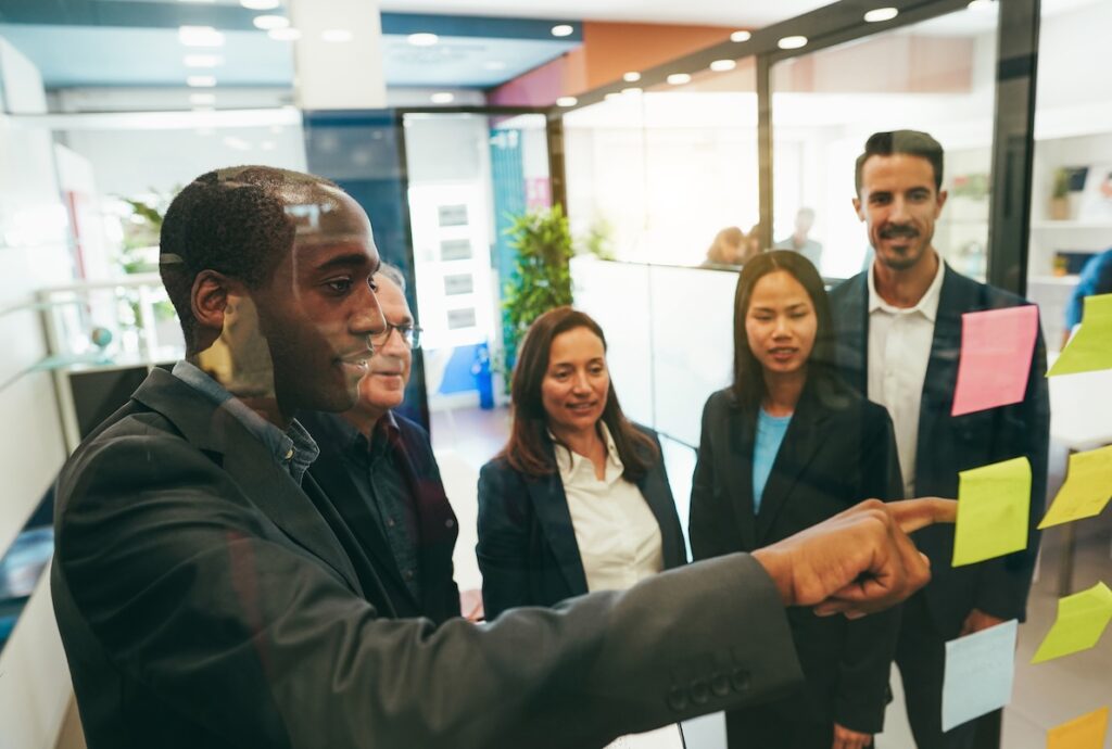 A group of employees discuss strategies to get a promotion.
