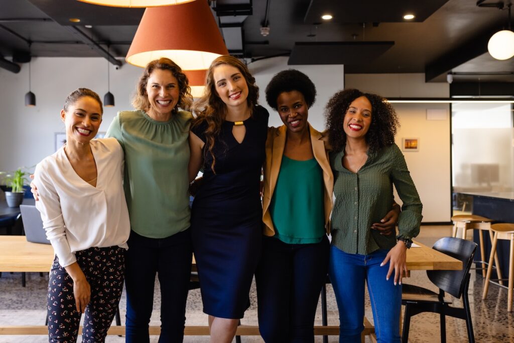 A tight knit group of female coworkers enjoy the benefits of womens networking.