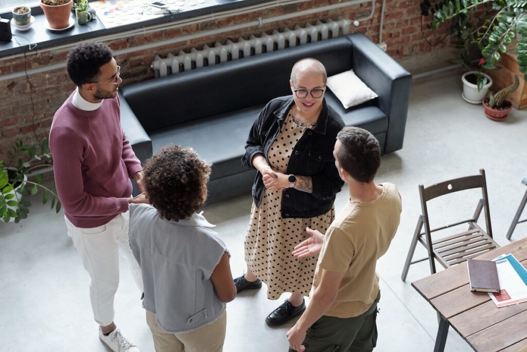 A diverse group of professionals talks at a networking event.