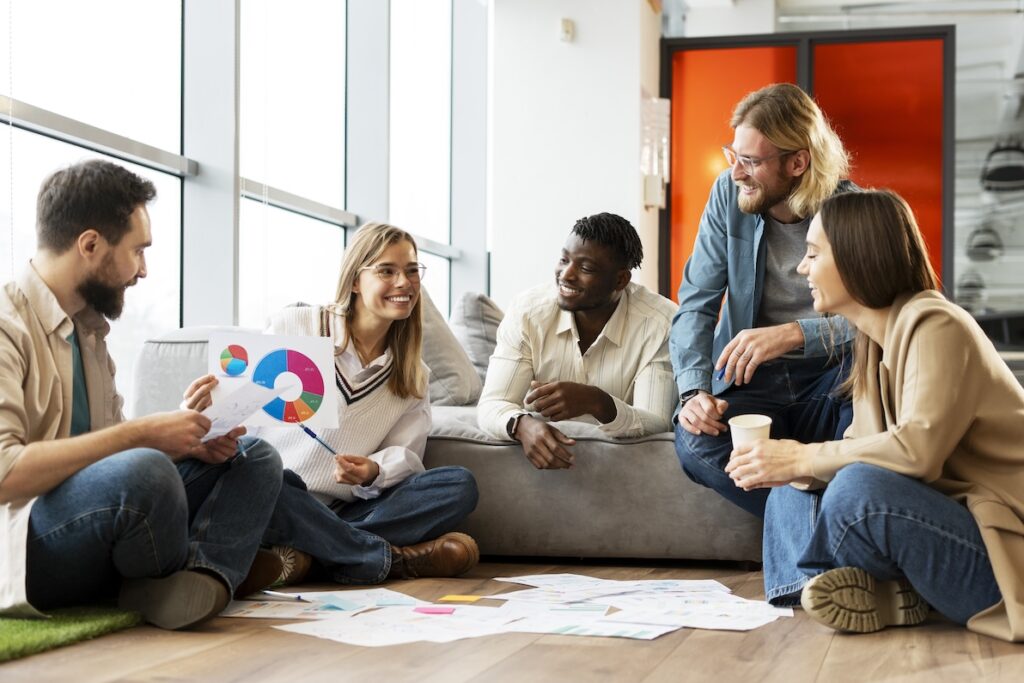 A team of young professionals goes through an onboarding checklist with a new hire.