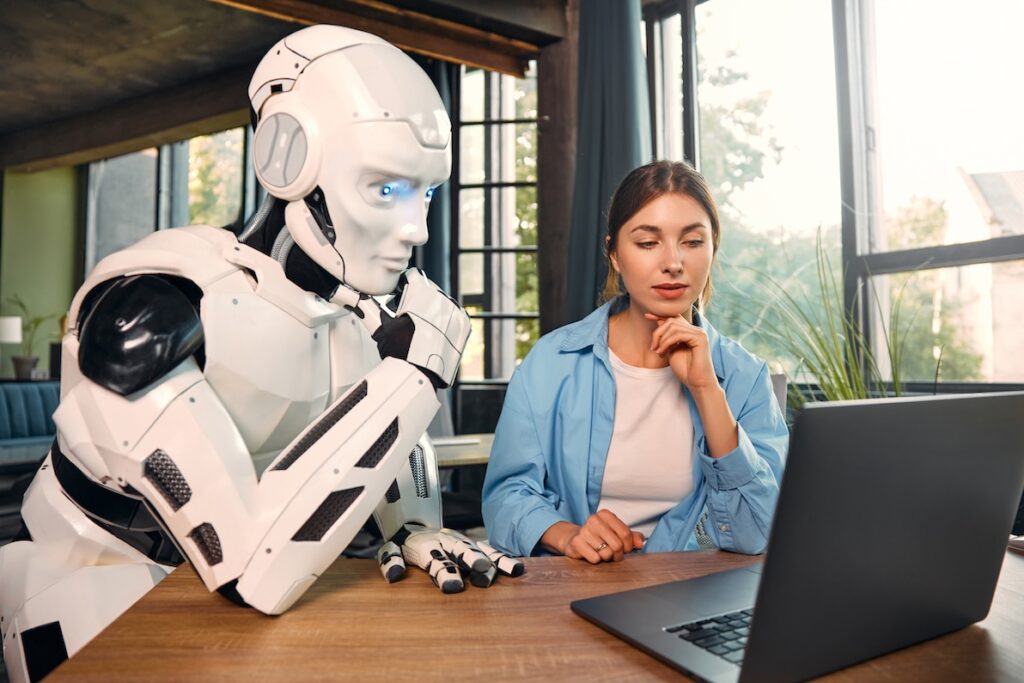 A robot and woman demonstrate the need for a human touch in ai recruiting.